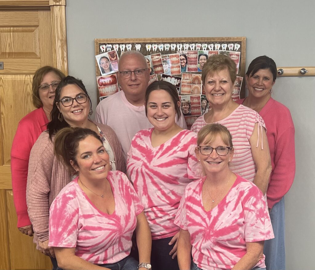 the More than a Smile team wearing matching pink shirts.